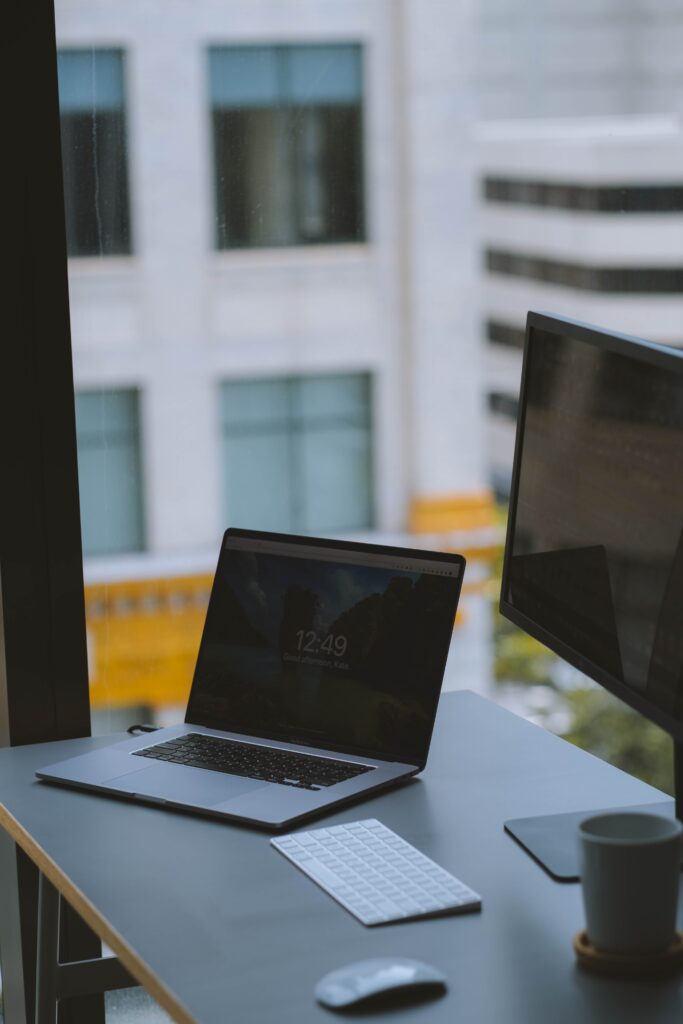 Arbeitsplatz der SMK Werkstatt mit Laptop und Bildschirm am Fenster